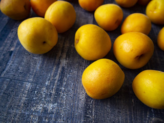 ripe juicy apricots on a wooden table