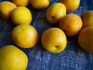 ripe juicy apricots on a wooden table