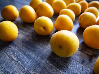 ripe juicy apricots on a wooden table