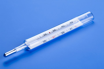 medical thermometer on a blue