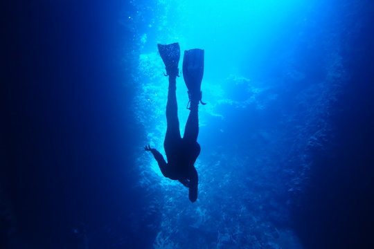 Silhouette Of A Diver In Blue Water While Cave Diving In Neiafu, Vavau, Tonga