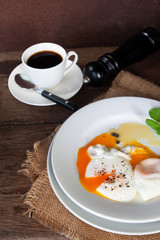 Healthy breakfast, poached eggs and black coffee on wooden table, Nutrition food