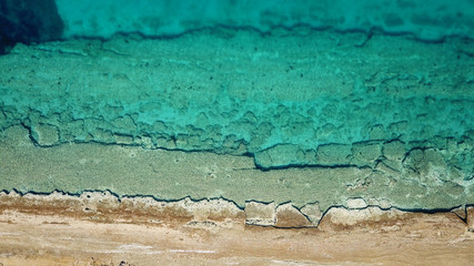 Aerial drone bird's eye view photo from turquoise clear water seascape in island of Shinousa or...