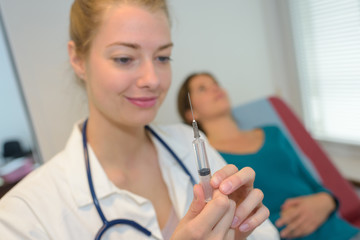 beautiful nurse is holding injection