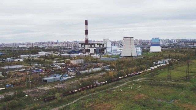 Aerial drone view of power station with cooling towers rejecting waste heat