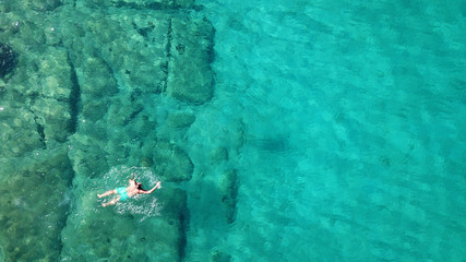 Fototapeta na wymiar Aerial drone bird's eye view photo from turquoise clear water seascape in island of Shinousa or Schinoussa, Cyclades, Greece