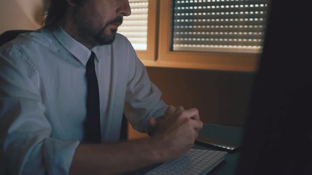 Thinking and concentration, adult caucasian businessman in dark office interior