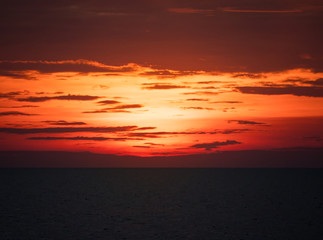 Fototapeta premium Colorful orange red sunset over a lake
