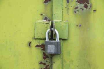 green with rust iron gate closed on the lock