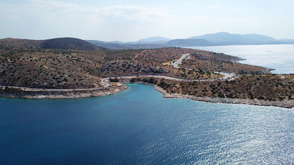 Aerial drone bird's eye view photo of road in Athens riviera seaside known limanakia forming small bays with turquoise clear waters, Vouliagmeni, Attica, Greece