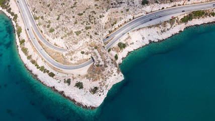 Aerial drone bird's eye view photo of Tunnel in Athens riviera seaside road known as hole of Karamanlis, Attica, Greece