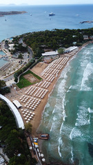 Aerial drone bird's eye photo of famous celebrity wavy sandy beach of Astir or Asteras in south Athens riviera with turquoise clear waters, Vouliagmeni, Greece