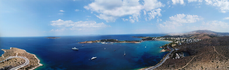 Aerial drone bird's eye view panoramic ultra wide 180 degrees photo of iconic Astir beach and Peninsula, Vouliagmeni, Athens riviera, Attica, Greece