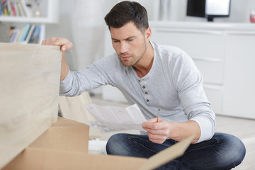 young man assembling furniture