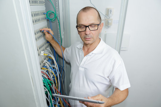 technician using tablet in server room at the data centre