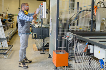 Workman setting up factory equipment