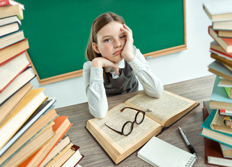 Sleepy exhausted or bored young student. Photo of schoolgirl, creative concept with Back to school theme