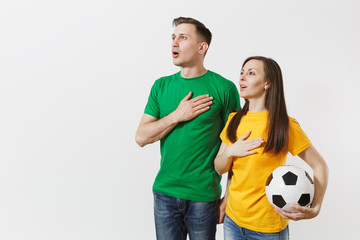 Emotional couple, woman man, football fans in yellow green t-shirt cheer up support team with...