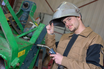 happy apprentice welder at work in the plant