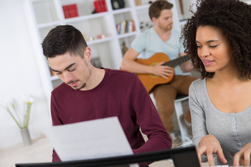 multiracial music band performing in a recording studio