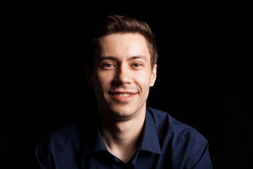 Portrait with fashion lighting of young man on black background