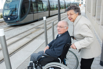 man with disease on a wheelchair and his lovely woman © auremar
