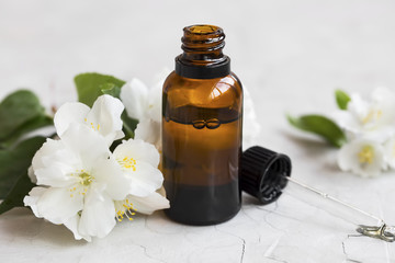 Jasmine essential oil. Bottle of jasmine aromatherapy oil with dropper
