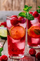 Raspberry Mojito Lemonade with lime and fresh mint in glass on wooden background