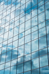 Glass facade of modern city high buildings, cloud reflection