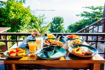 Fototapeta premium Healthy breakfast set with egg bacon pancakes orange juice milk bread and coffee