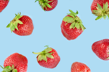 Fresh red strawberry isolated on a blue background. Summer berries. The concept of healthy eating.