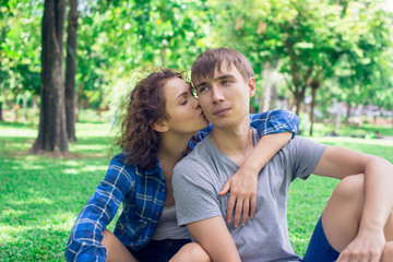 Fototapeta premium Girl kissing a boy outdoor