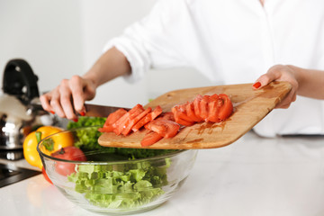 Cropped image of young woman in kitchen