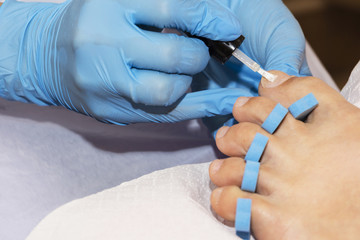 Woman feet receiving pedicure. Close up concept.