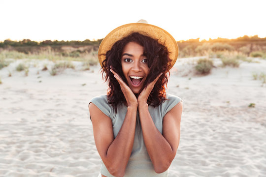 Close up of excited young african girl in summer hat
