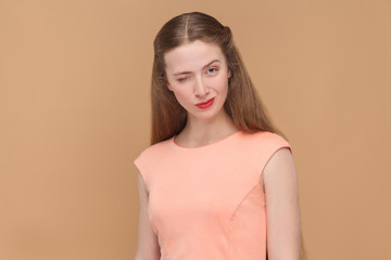 Obraz premium funny woman winking and looking at camera.