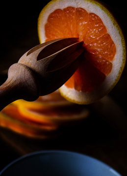 Orange being squeezed.