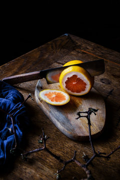 Cutting an orange on a wood table.