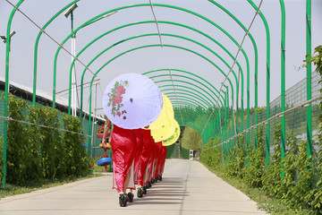 Women in cheongsam are walking
