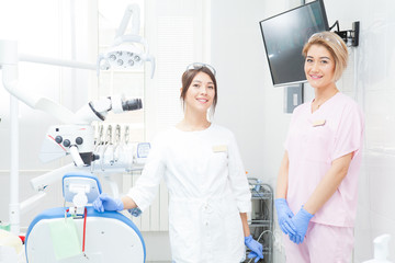 Fototapeta premium Two young girls-dentists in the treatment room.