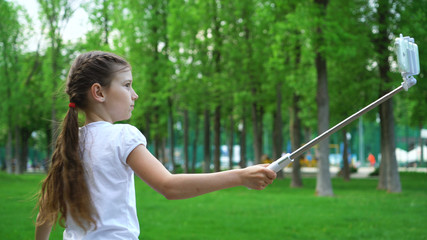closeup of carefree young girls making selfies skating rollers in park outdoor. Health, wellness, sport concept. leisure time