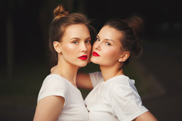 two beautiful girls with red lips