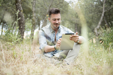 Fototapeta premium handsome man looking at his tablet