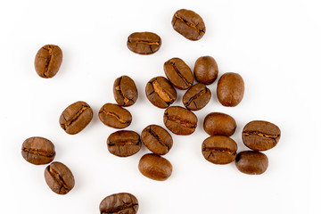 close up of medium or dark roasted coffee beans isolated on white background, can be used as a background or graphic object in your ads.