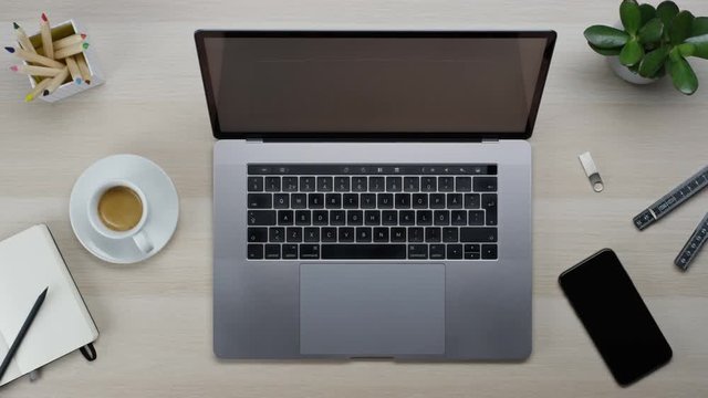 Male hands typing laptop on white clean minimalistic table with top view, gestures and finger movements macbook