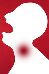 concept of disease diagnosis and pain on silhouette - close-up abstract patient with tonsillitis or flu in throat, viral infection in opened mouth, isolated on red background, top view, flat lay.