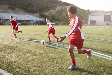 Group Of Male High School Students Playing In Soccer Team