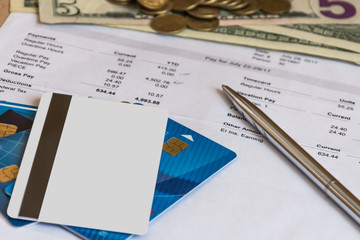 Finance accounting.Paycheck, credit cards, currency top view. Income calculation. 