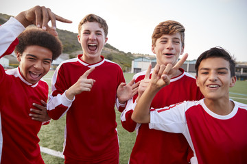 Portrait Of Male High School Soccer Team Celebrating