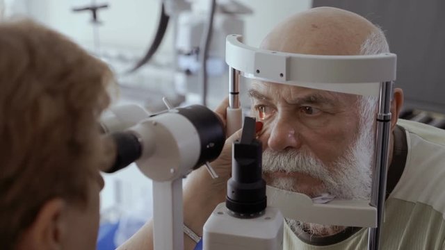 Doctor check eyesight of senior man with biomicroscope